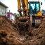 excavator digging precise utility trench on residential property in colorado springs