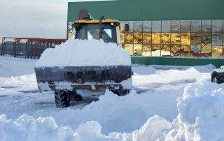 Commercial snow plow clearing snow