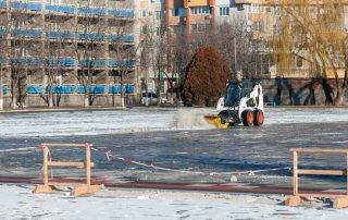 Commercial parking lot snow removal in progress at a large Colorado Springs property