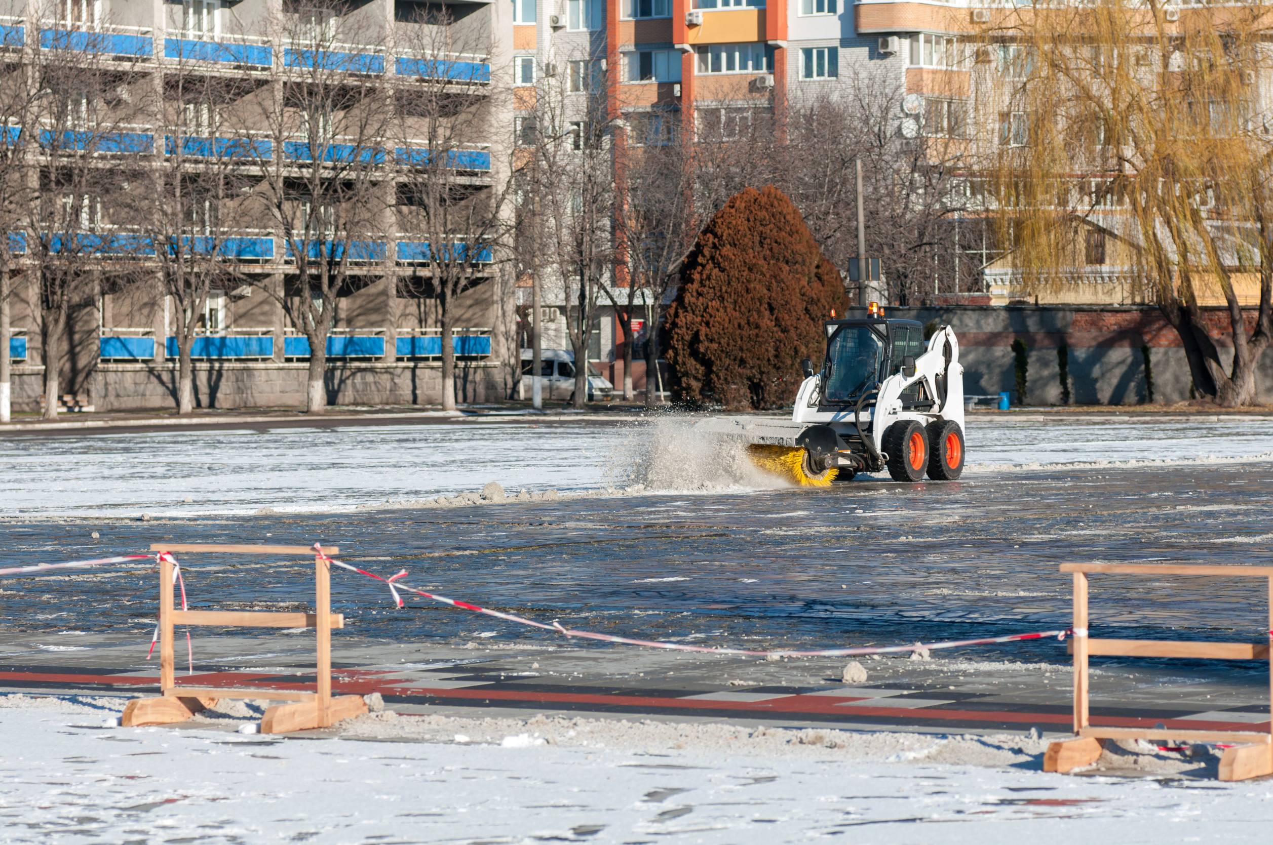 Commercial parking lot snow removal in progress at a large Colorado Springs property