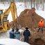 Emergency excavation crew working on a frozen commercial site in Colorado Springs during winter