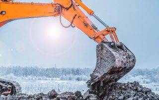 Excavation equipment operating on a winter construction site in Colorado Springs