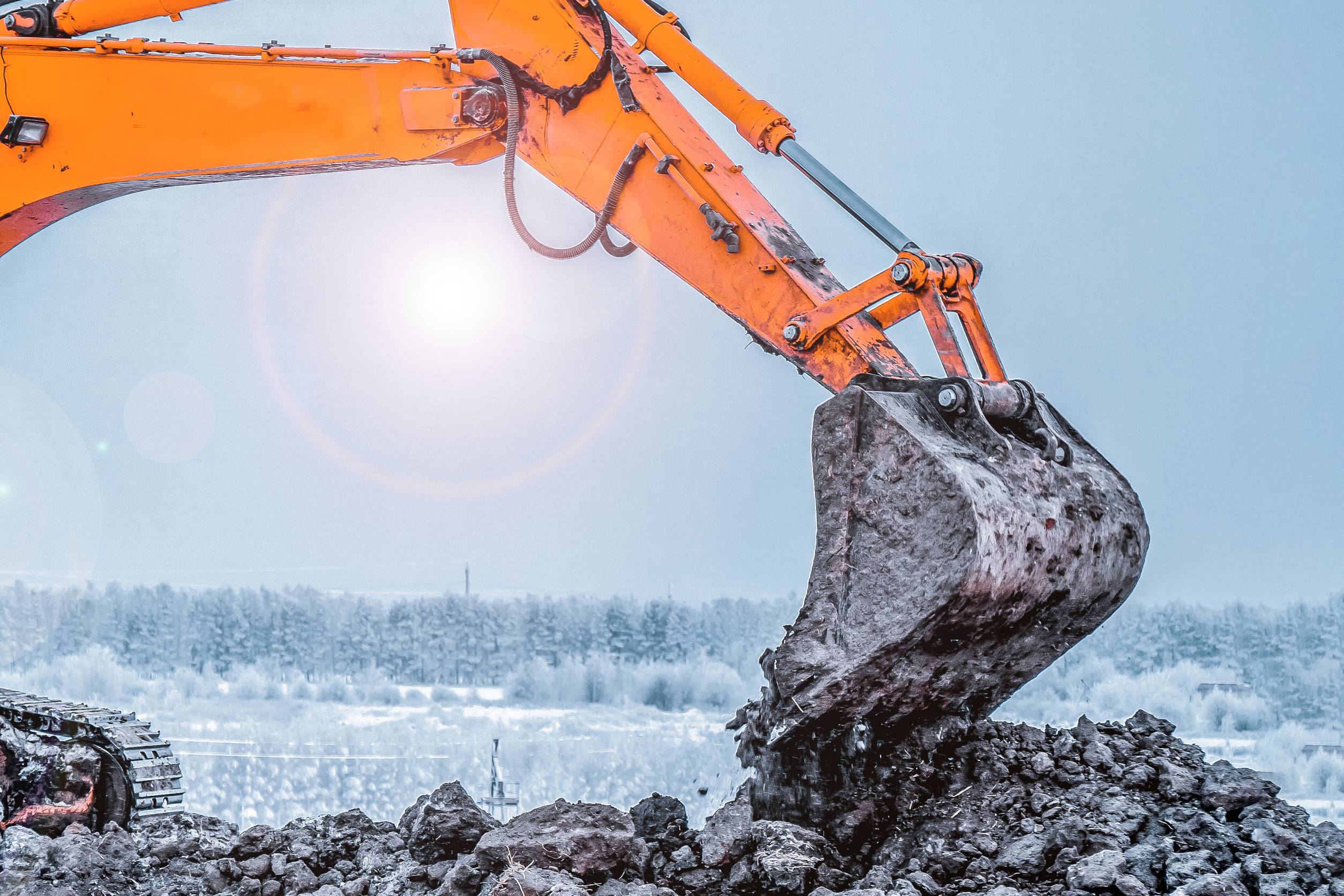 Excavation equipment operating on a winter construction site in Colorado Springs